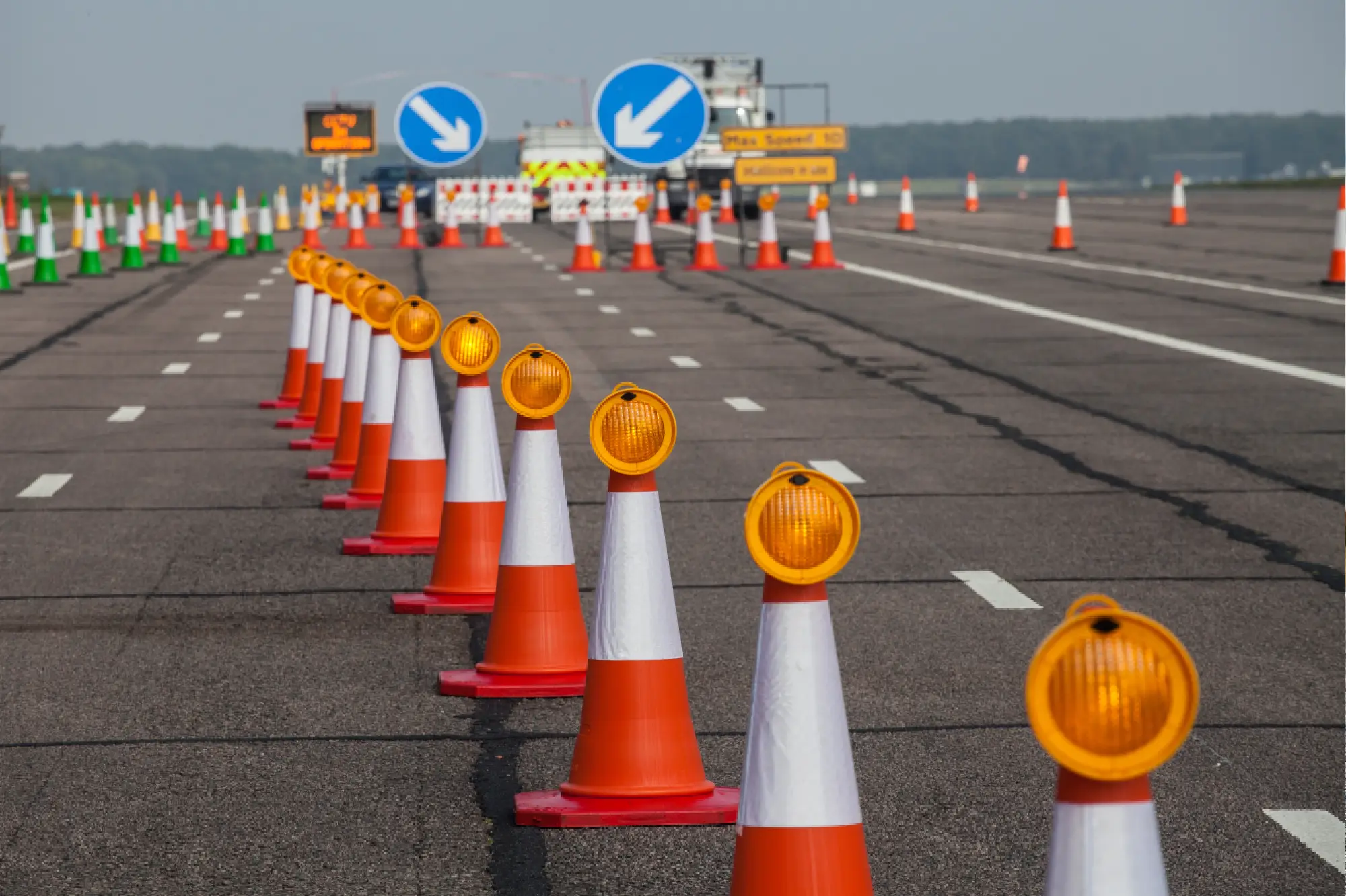 Road closed; traffic cones and lights.